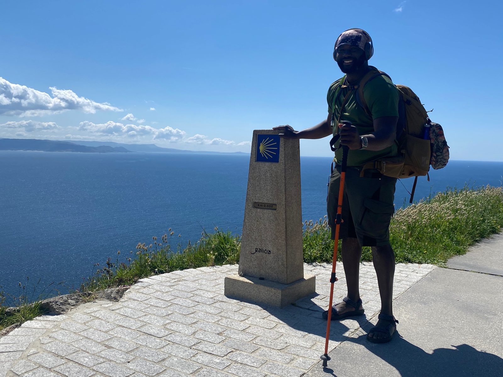 Brown Charité with his hand on the rock at Finisterre on the Atlantic coast